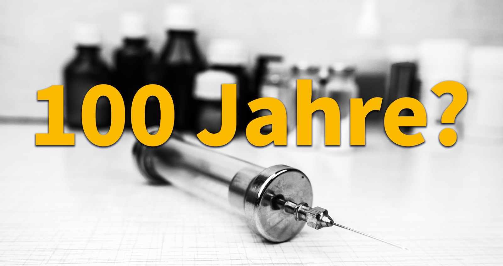 Eine alte Insulinspritze vor Flaschen mit Insulin, davor steht: "100 Jahre?"