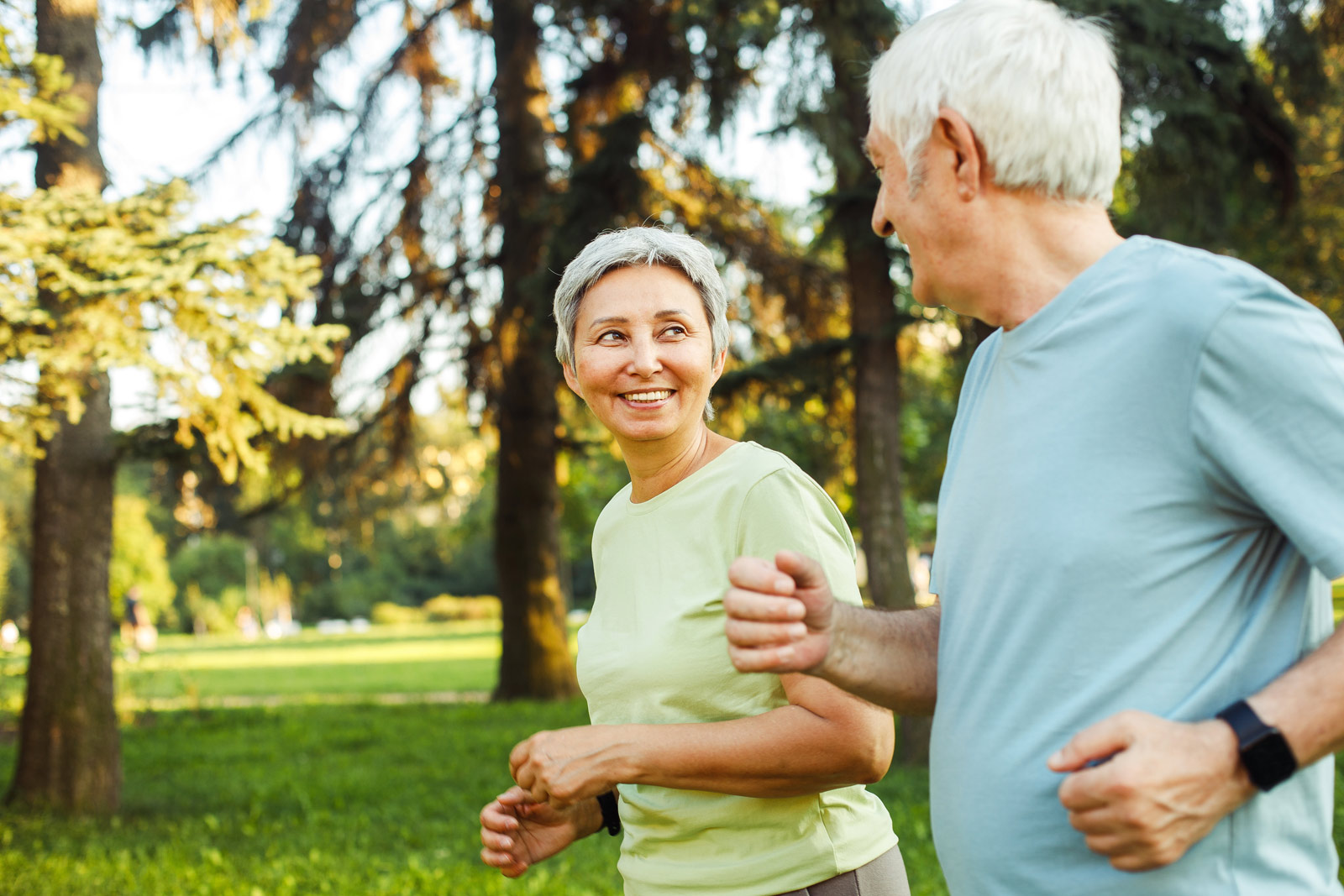 Zwei ältere Menschen joggen im Park